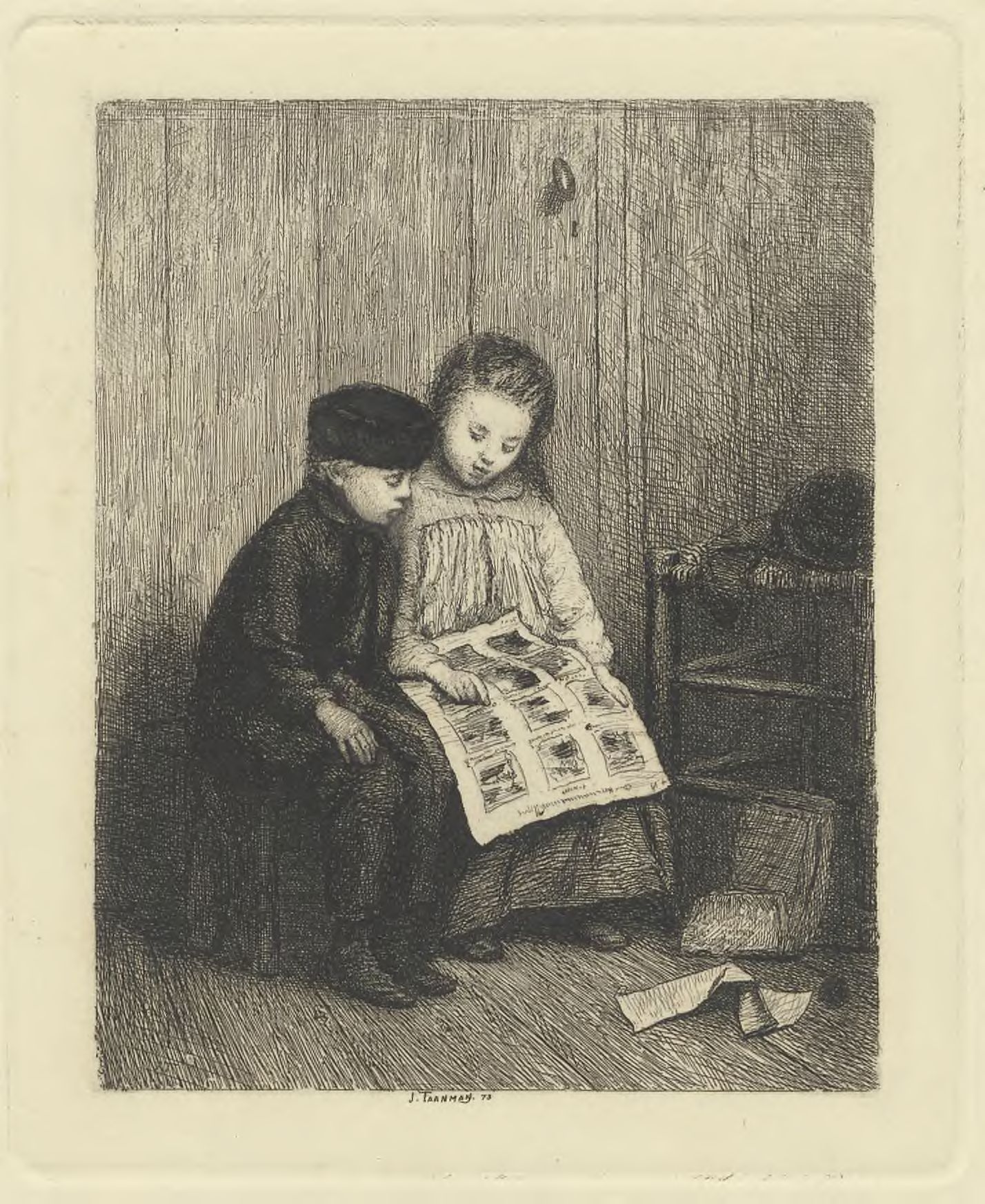 Two children looking at pictures /